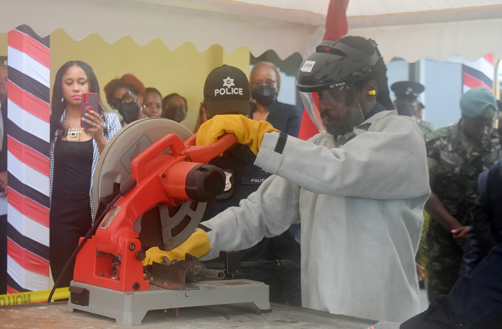 The Honourable Fitzgerald Hinds, Minister of National Security, Trinidad and Tobago, destroys an illicit firearm using specialist equipment.